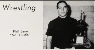 Yearbook clipping headed 'Wrestling' showing Phil Lane, 'Mr. Hustle,' standing beside a trophy.