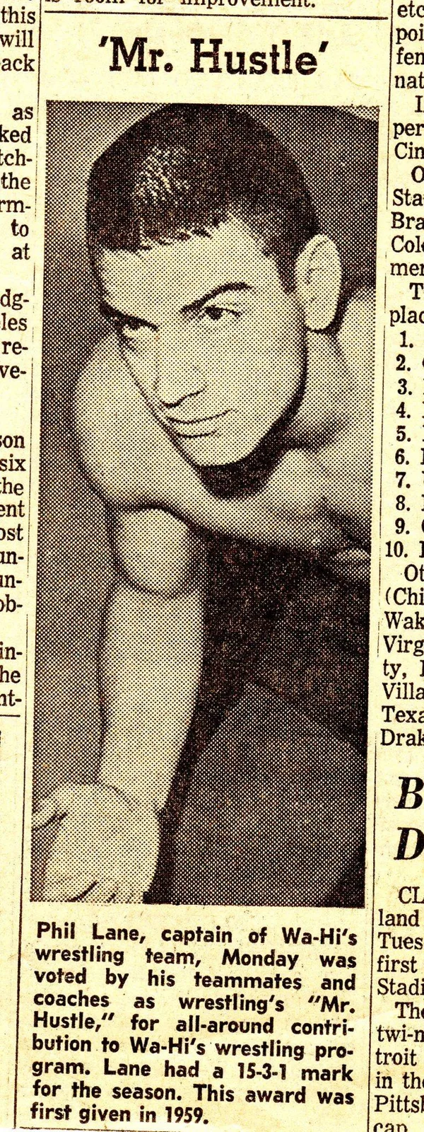 Newspaper clipping titled 'Mr. Hustle' with a photo of Phil Lane, Wa-Hi wrestling captain, voted Mr. Hustle by teammates and coaches after a 15-3-1 season.