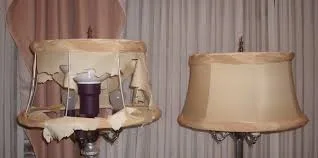 Two lampshades side by side: on the left, a tattered, torn fabric shade exposing its wire frame and bulb; on the right, a smooth, intact beige shade.