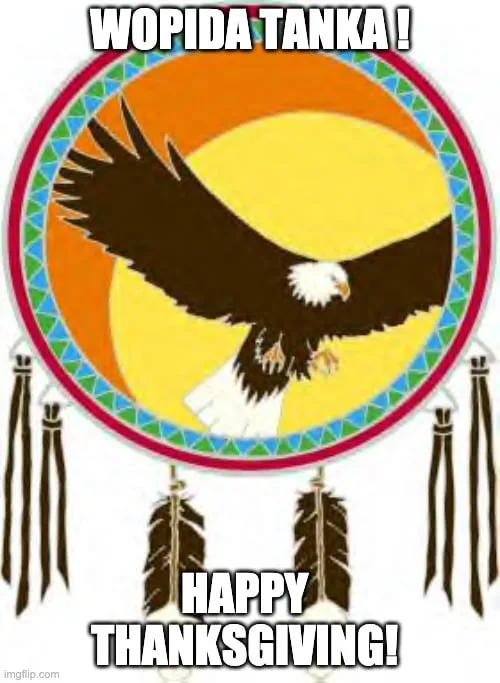 A bald eagle with outstretched wings flies across a yellow and orange sun inside a beaded circle hung with feathers. Text reads "Wopida Tanka! Happy Thanksgiving!"
