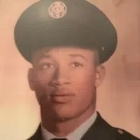 Vintage portrait of a young Leonard Gavin in a military dress uniform and peaked service cap.