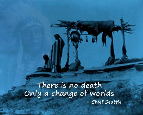 Blue-tinted historical photograph of two Indigenous people beside a scaffold burial platform hung with hides on a rocky hill, with a faded portrait of an elder in a feather headdress. Text reads: "There is no death, only a change of worlds" – Chief Seattle.
