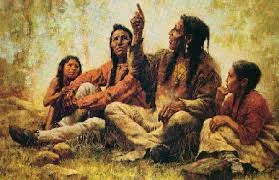 Painting of an Indigenous elder with long braids pointing skyward as he speaks to a man and two children seated with him on the grass in a sunlit forest.
