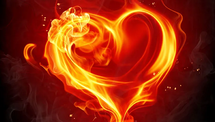 A glowing heart shape formed of swirling orange and yellow flames against a dark red, smoky background with drifting sparks.