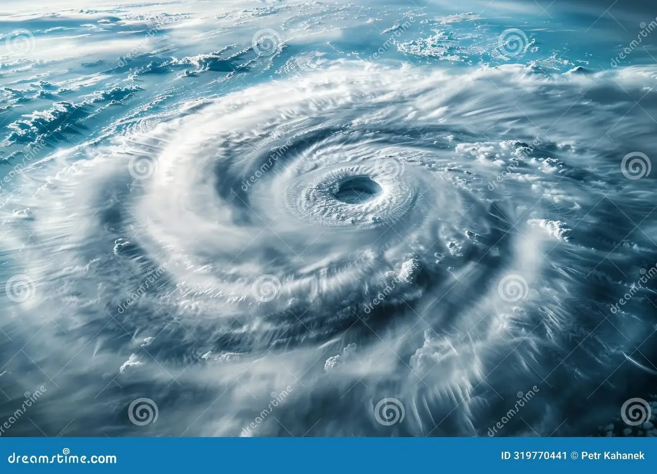 Aerial view from high above of a massive hurricane swirling over the ocean, white cloud bands spiraling around a calm, open eye at its center.