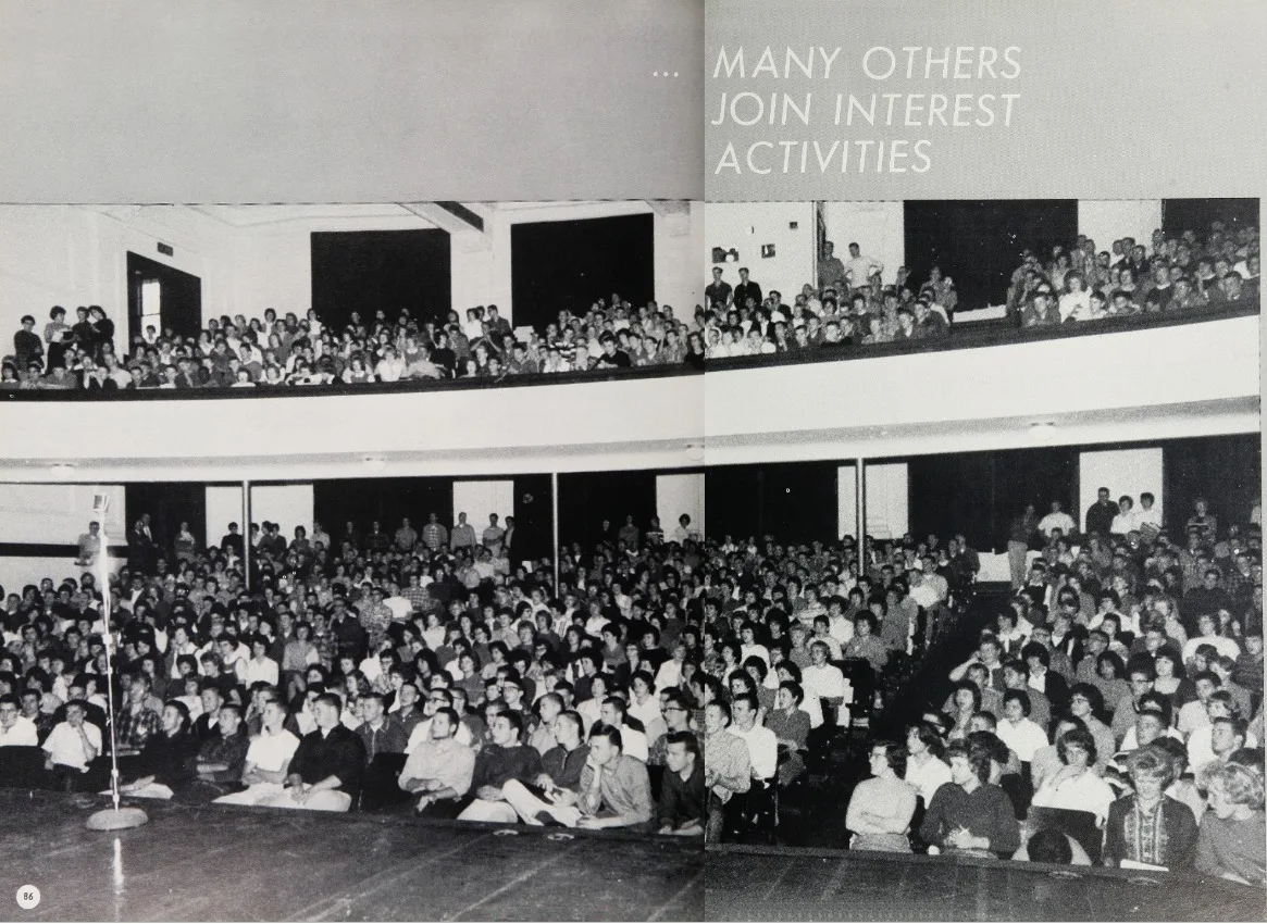 Black-and-white yearbook spread headed "Many others join interest activities," showing a packed school auditorium with students filling the floor seats and balcony.